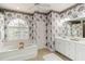 Floral bathroom features a soaking tub, patterned wallpaper, and a vanity at 1860 Citron St, Punta Gorda, FL 33980
