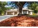 Inviting home exterior featuring a three car garage, neutral paint, and manicured front yard at 1860 Citron St, Punta Gorda, FL 33980
