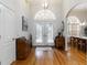 Elegant foyer with hardwood floors, decorative lighting, and arched doorway leading to dining room at 1860 Citron St, Punta Gorda, FL 33980