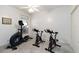 Workout room offering an elliptical machine, two stationary bikes, and a ceiling fan at 1860 Citron St, Punta Gorda, FL 33980