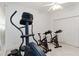 Home gym equipped with an elliptical and stationary bikes, complemented by natural light at 1860 Citron St, Punta Gorda, FL 33980