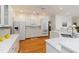 Spacious kitchen featuring white cabinetry, stainless steel appliances, and hardwood floors at 1860 Citron St, Punta Gorda, FL 33980