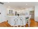 Bright kitchen with white cabinets, quartz countertops, and bar stool seating at 1860 Citron St, Punta Gorda, FL 33980