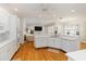 Open concept kitchen with white cabinetry, hardwood floors, and views of living area at 1860 Citron St, Punta Gorda, FL 33980
