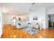 Spacious living room featuring hardwood floors, a white sectional couch, and an open floorplan at 1860 Citron St, Punta Gorda, FL 33980