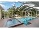 Enclosed swimming pool with a spa, beautiful landscaping, and lush greenery at 1860 Citron St, Punta Gorda, FL 33980