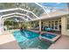 Inviting screened-in pool area with a spa and lounge chairs, perfect for outdoor relaxation at 1860 Citron St, Punta Gorda, FL 33980