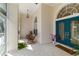 Inviting front porch with rocking chairs, decorative tile flooring, and a vibrant teal front door at 1860 Citron St, Punta Gorda, FL 33980