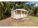 A small shed features durable vinyl siding, a covered porch, and matching white trim at 1860 Citron St, Punta Gorda, FL 33980
