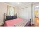 Cozy bedroom with a wrought iron bed frame, hardwood floors, and a closet at 2216 13Th W Ave, Bradenton, FL 34205