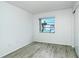 A brightly lit room features wood-look floors and a window offering community views at 2227 Sunset Dr # E22, Bradenton, FL 34207
