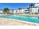 Resort-style community pool surrounded by lush landscaping and comfortable lounge chairs at 2227 Sunset Dr # E22, Bradenton, FL 34207