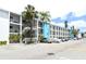 Condominium building with parking and exterior stairs surrounded by palm trees at 2227 Sunset Dr # E22, Bradenton, FL 34207