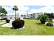Manicured community green space with mature landscaping, trees and white buildings at 2227 Sunset Dr # E22, Bradenton, FL 34207