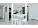 Modern kitchen with stainless steel appliances, white cabinets, and a breakfast bar with seating at 2227 Sunset Dr # E22, Bradenton, FL 34207