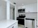 Modern kitchen featuring stainless steel appliances, white cabinets, and subway tile backsplash at 2227 Sunset Dr # E22, Bradenton, FL 34207
