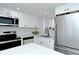 Bright white kitchen featuring stainless steel appliances, modern cabinetry, and subway tile backsplash at 2227 Sunset Dr # E22, Bradenton, FL 34207