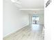 Spacious living area with light wood floors, ceiling fan, and sliding glass doors to a private balcony at 2227 Sunset Dr # E22, Bradenton, FL 34207
