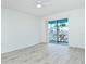 Bright living room featuring light floors, ceiling fan and a balcony with a table and seating at 2227 Sunset Dr # E22, Bradenton, FL 34207