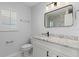 Bathroom with granite vanity top, framed mirror, and modern lighting at 2301 Arborfield Ln, Sarasota, FL 34235
