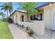 Charming home with a courtyard entry, stucco wall and tropical landscaping detail at 2301 Arborfield Ln, Sarasota, FL 34235