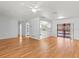 Open concept living area with wood floors, leading to kitchen and pool area at 2301 Arborfield Ln, Sarasota, FL 34235