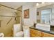 Accessible bathroom with tiled shower, grab bars, and updated vanity at 2605 Sunnybrook Dr, Sarasota, FL 34239