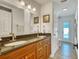 Bathroom featuring dual sinks, wood cabinets, and access to the pool at 2605 Sunnybrook Dr, Sarasota, FL 34239