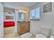 Bathroom featuring vanity with a granite countertop, matching mirror, and toilet at 2605 Sunnybrook Dr, Sarasota, FL 34239