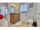 Bathroom featuring vanity with a granite countertop, matching mirror, and toilet at 2605 Sunnybrook Dr, Sarasota, FL 34239