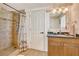 Bathroom featuring a shower, vanity with granite countertop, and a matching framed mirror at 2605 Sunnybrook Dr, Sarasota, FL 34239