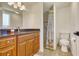 Bright bathroom featuring a shower, granite countertop, matching framed mirror, and toilet at 2605 Sunnybrook Dr, Sarasota, FL 34239