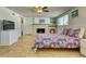 Bright bedroom with a brick fireplace and neutral tile flooring, creating a warm, inviting space at 2605 Sunnybrook Dr, Sarasota, FL 34239