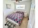 Cozy bedroom with natural light, tile flooring and a stylish geometric rug at 2605 Sunnybrook Dr, Sarasota, FL 34239