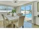 Bright dining room with pool views through sliding glass doors at 2605 Sunnybrook Dr, Sarasota, FL 34239