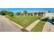Charming single-story home featuring a lush green lawn, a palm tree, and a welcoming front porch with arched columns at 2605 Sunnybrook Dr, Sarasota, FL 34239