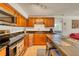 Modern kitchen features stainless steel appliances, granite countertops, and wood cabinetry at 2605 Sunnybrook Dr, Sarasota, FL 34239