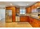 Traditional kitchen featuring stainless steel appliances, and brown cabinets at 2605 Sunnybrook Dr, Sarasota, FL 34239