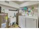 Laundry room features a sink, a new dryer and washing machine, and shelving for storage at 2605 Sunnybrook Dr, Sarasota, FL 34239