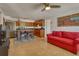 Open concept living area with bright kitchen, tile flooring, and cozy red sofa at 2605 Sunnybrook Dr, Sarasota, FL 34239