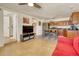 Spacious living area with tile floors, tv, and kitchen access at 2605 Sunnybrook Dr, Sarasota, FL 34239