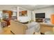 Open-concept living room with comfortable seating and a view of the kitchen, perfect for modern living at 2605 Sunnybrook Dr, Sarasota, FL 34239