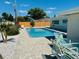 Beautiful backyard pool with pavers, outdoor seating, and a well-maintained fence at 2605 Sunnybrook Dr, Sarasota, FL 34239