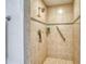 Modern tiled shower with built-in shelving and grab bar for accessibility at 2605 Sunnybrook Dr, Sarasota, FL 34239