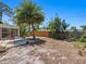 Spacious backyard area featuring a patio, lush landscaping, and a wooden fence for added privacy at 2720 Herwald St, Sarasota, FL 34231