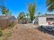 Lush backyard space featuring a patio with outdoor seating and mature trees with fenced border at 2720 Herwald St, Sarasota, FL 34231