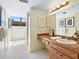 Bright bathroom with a walk-in shower, large mirror with vanity lighting, and under sink cabinets at 2720 Herwald St, Sarasota, FL 34231
