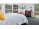 Bedroom featuring a bookcase, natural light from the windows, and dark, cozy carpet at 2720 Herwald St, Sarasota, FL 34231