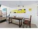 Elegant dining area featuring a rustic table, unique lighting fixtures, and modern artwork, perfect for hosting gatherings at 2720 Herwald St, Sarasota, FL 34231