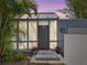 Stylish home entrance with a glass-paneled door, bright curtains, and potted flowers, creating a welcoming ambiance at 2720 Herwald St, Sarasota, FL 34231